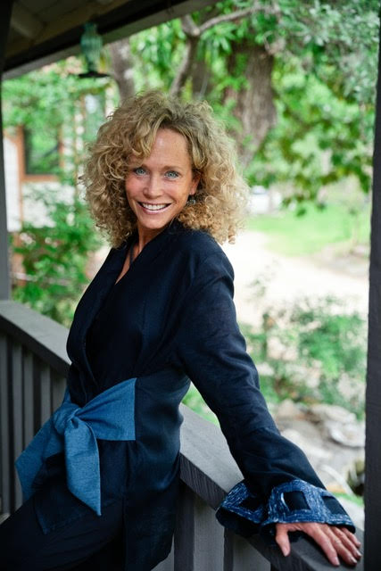 Stephenie Purnell leaning against a porch rail outdoors